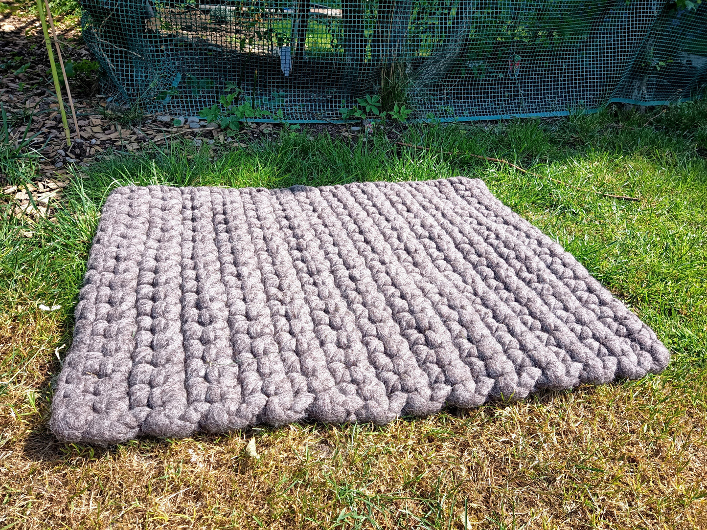 Felted dog mat made from virgin sheep's wool, carrying strap included